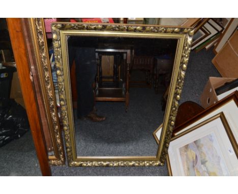 A rectangular gilt framed mirror , shaped surrounds ; others similar (3)