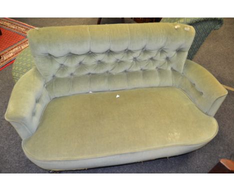 A Victorian button back sofa, green velvet upholstery, turned legs, c.1870