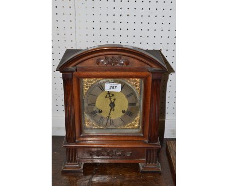 An early 20th century mahogany mantel clock , brass dial , Roman numerals 
