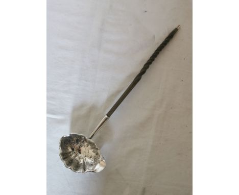 A Georgian silver punch ladle with twisted whale bone handle. Hallmarked to the underside of the spout for: 'London 1772' and
