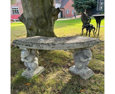 A reconstituted stone curved garden bench with squirrel supports, 50cm high x 80cm wide x 38cm deep