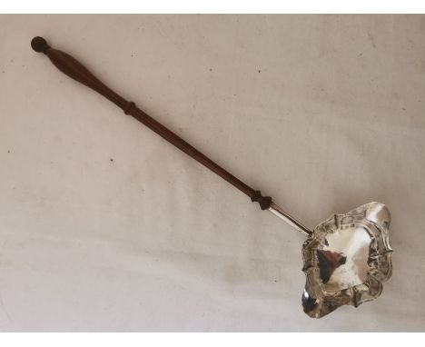A Georgian silver double spouted punch ladle with turned wooden handle. Hallmarked under one of the spouts for: ' London, 177