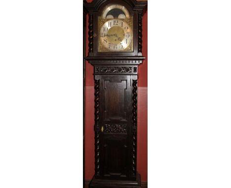 A George III brass faced moon phase clock in a later Victorian carved oak and barley twist case, with&nbsp;an 8-day key wound