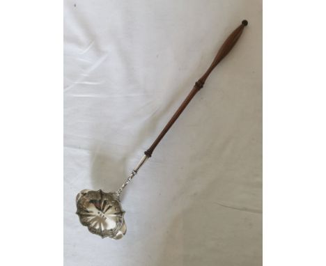 A Georgian silver punch ladle with double spout and a turned wooden handle. The inside of the bowl is hallmarked for London 1