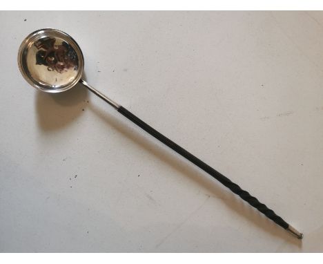 A Georgian white metal toddy ladle with whale bone handle. 38cm long. (1)