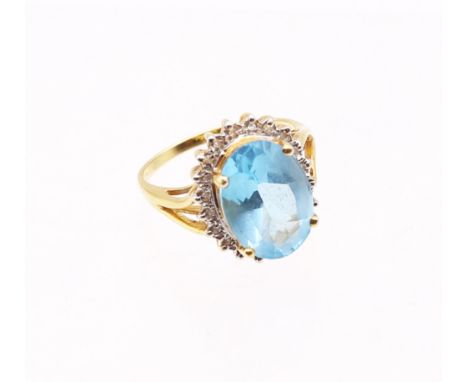18ct Gold Topaz and Diamond Ring&nbsp; The ring has an Oval Brilliant Cut Topaz that measures approx. 13.97mm x 9.90mm x 5.84