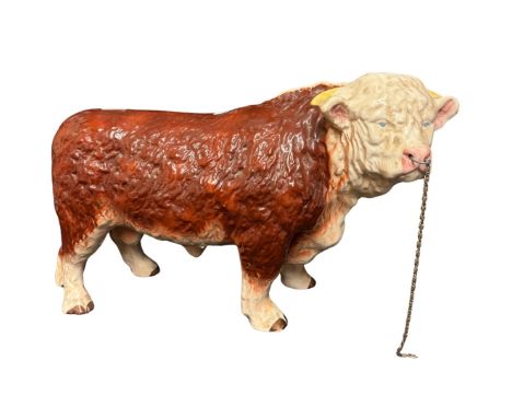 A large Melba ceramic bull with metal nose ring and chain, 42cm long