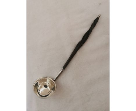 A small Georgian silver ladle with twisted whale bone handle. Hallmarked to the outer side of the bowl for: 'London 1806'. 18