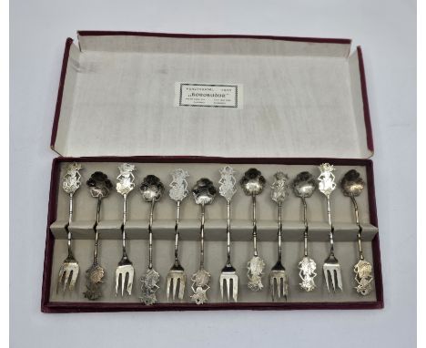 A boxed 800 Silver fork and spoon set.- Indonesia Borobudour. The spoon bowls designed as lotus flowers and each piece topped