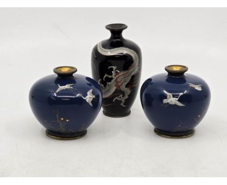 A fine quality pair of miniature Japanese Meiji Period Cloisonné vases - of squat form decorated with Cranes flying above gra