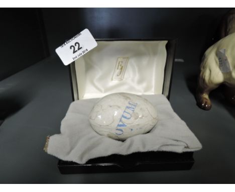 A vintage ceramic hen egg with transfer print marked Ovum 