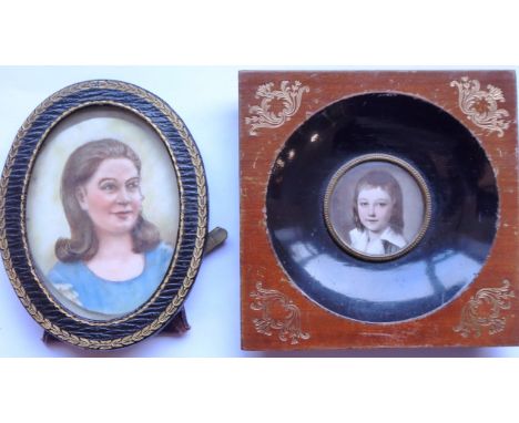 An early 20th century oval easel-style leather frame with gilt tooling housing a shoulder length female portrait study on ivo