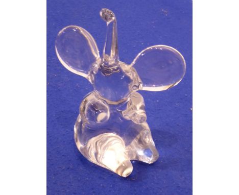 A heavy clear glass model of a seated elephant, trunk elevated and with outstretched wide ears, signed Daum, France, 25.5cm h