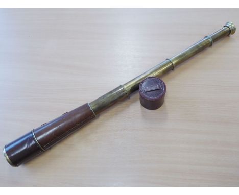 An early-20th century four-drawer brass and brown patinated leather telescope; maker's mark of Broadhurst Clarkson &amp; Co.,