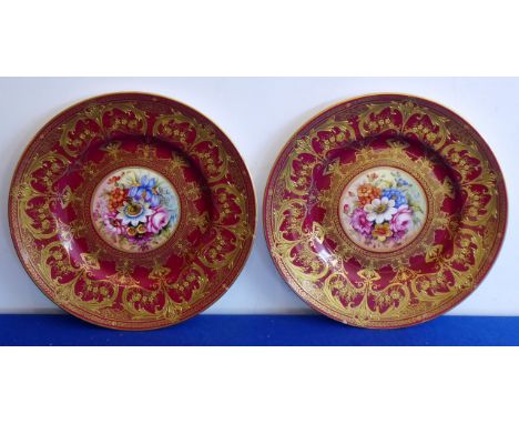 A very fine pair of Royal Worcester porcelain cabinet plates; both superbly gilded against a puce ground and with central flo