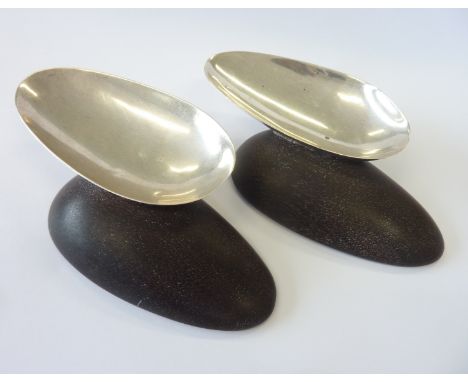William Spratling (1900-1967); a pair of circa 1950s Mexican silver egg-shaped trinket dishes upon conforming hardwood bases,