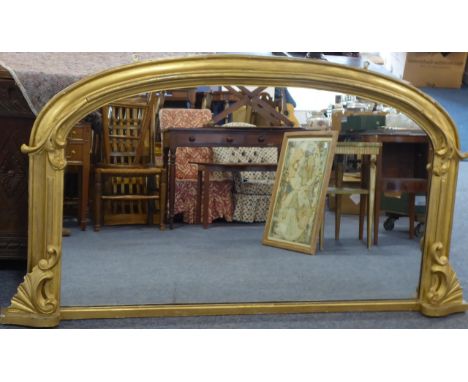 A large 19th Century gilt framed overmantle the top section with scrolling foliage above two terminals with 'C' scrolls and f