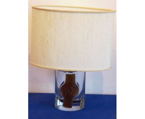 Daum, France; a modernist crystal table lamp having an applied moulded glass front, oval shade (probably original), signed to