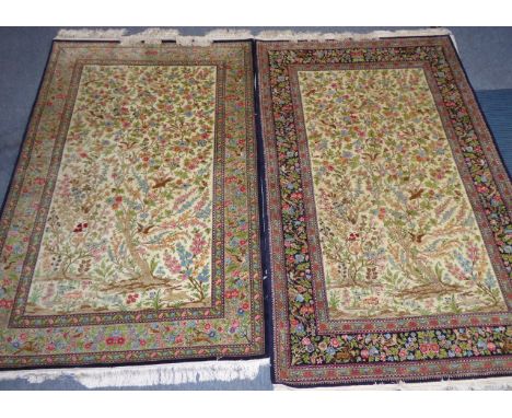 A very fine matched pair of Persian silk mixture carpets with a very high density of knots per square, the slightly larger wi