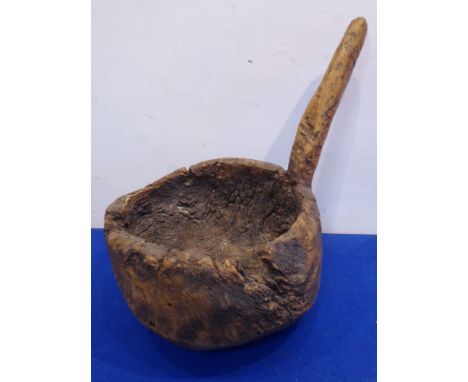 A primitive heavy gnarled root carving as a handled scoop or ladle (one piece of wood), the bowl 26cm diameter 