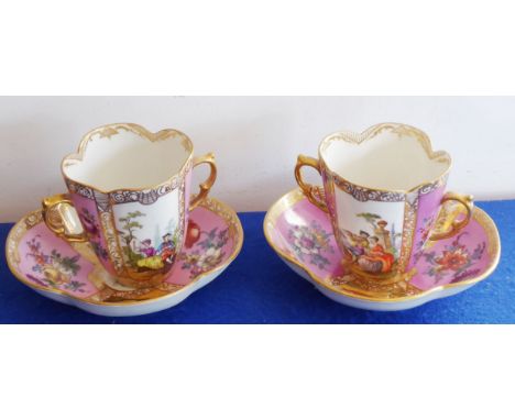 A pair of late-19th century Dresden-style two-handled porcelain chocolate cups on conforming quatrefoil-shaped stands; each p