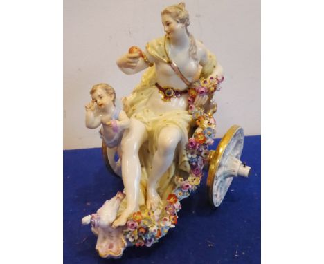 A late-19th / early-20th century Meissen-style porcelain figure model of a semi-clad female figure seated within a two-wheele