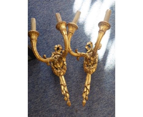 A pair of gilded carved wood and composition two-light electric wall appliques for restoration, ( 39cm high) 