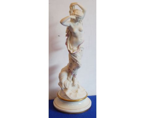 A Worcester biscuit porcelain model of a semi-clad muse standing upon a shell above stylised water, raised on gilt-trimmed sp