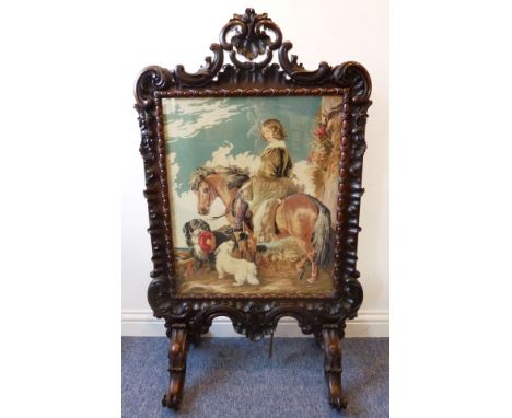 A very fine mid-19th century carved rosewood fire-screen; the whole profusely carved and decorated with 'C' scrolls; egg-and-