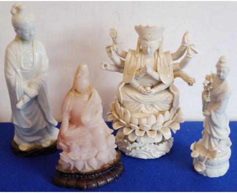An Oriental group, to include two ceramics models of Guanyin, a further ceramic model of ten armed deity seated upon a lotus 