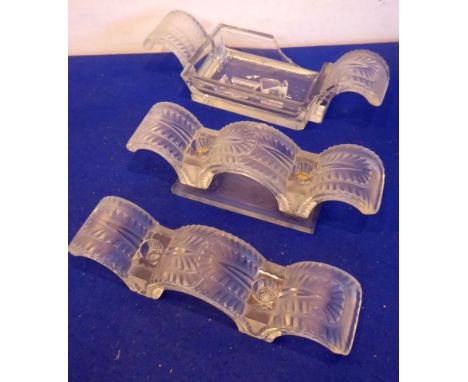 A three-piece Lalique group comprising a pair of two-light candelabra and a larger two-handled rectangular dish, each piece i