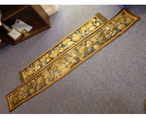 Two decorative table runners made up of 17th Century French tapestry pieces bounded and fringed at the ends, the first (145cm