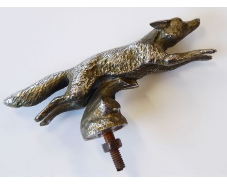 An Art Deco period chrome-plated car mascot modelled as a leaping fox, the underside of the circular affixing point stamped '