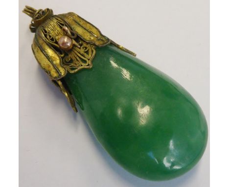 An early 20th century gilt-metal-mounted pear-shaped pendant set with a cold green hardstone (possibly jade), 4.5cm  CONDITIO