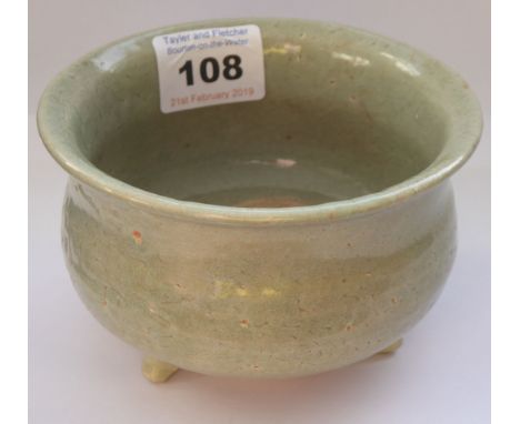 A Chinese Southern Song period celadon glaze ceramic tripod censer; everted lip and raised on three short splaying feet; 11cm