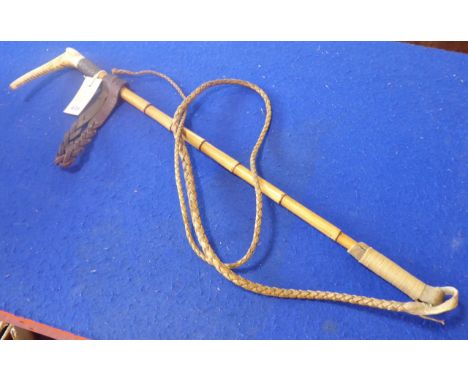 A late 19th century horn-handled coaching whip with repoussé  decorated silver ferule engraved with monogram, bamboo stick 