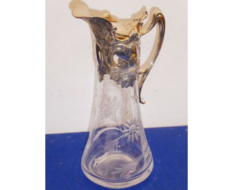 A late-19th/early-20th century conical-shaped glass claret jug engraved with flower heads; the silver-plated mount decorated 