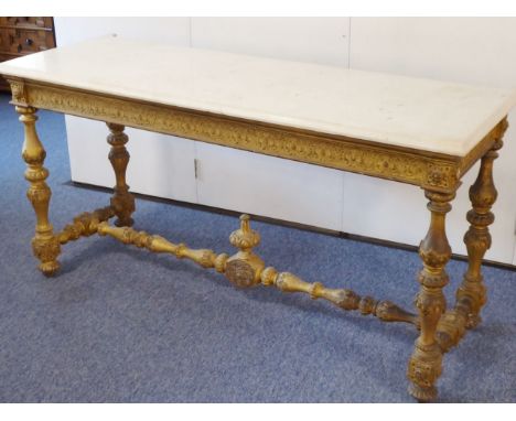 A 19th century (in earlier style) giltwood console table; white marble top over a frieze decorated in relief above turned leg