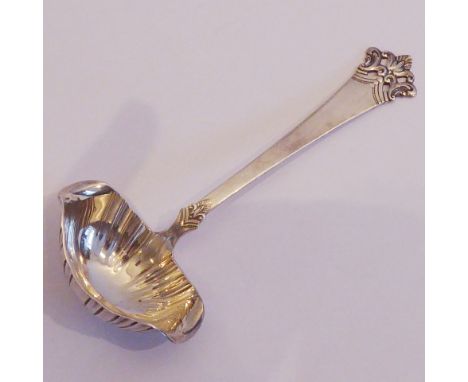 A 19th century Continental silver ladle; ornately decorated pierced terminal and the tapering handle leading down to a fluted