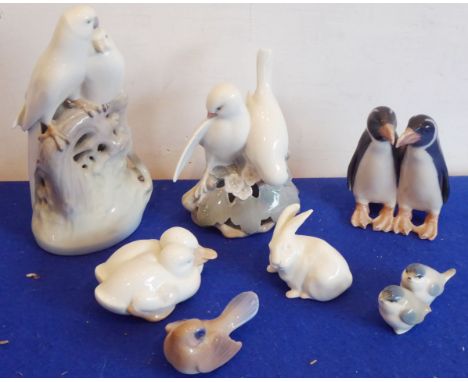 Four Royal Copenhagen porcelain two-bird models including parrots, songbirds, penguins, ducks and a single hare; together wit