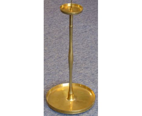 A large and heavy solid brass pricket stick with detachable circular drip-pan; the underside of the base with various marks a