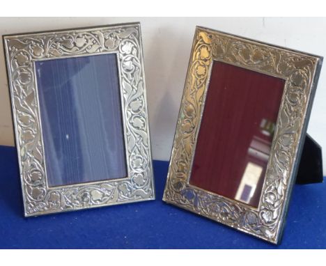 A matched pair of hallmarked Britannia standard silver photograph frames; decorated in Art Nouveau style with tulip heads and