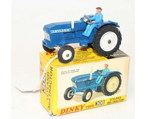 A Dinky Toys No. 308 Leyland 384 tractor comprising of blue body with white hubs and driver figure housed in the original pic