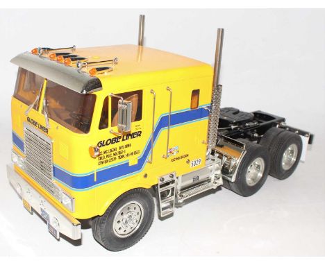 A Tamiya No. 56304 1/14 scale radio controlled model of a Globeliner tractor unit comprising of yellow and blue cab with blac