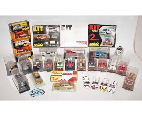A group of 32 unboxed and boxed Solido cars, mostly in the hard clear plastic cases with a racing theme, does also include 3 