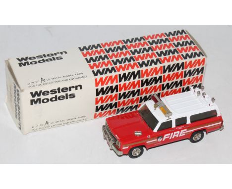 A Western Models 1/43 scale white metal kit built model of a Chevrolet C10 Suburban Fire Chief's car, finished in red and whi