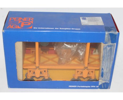 A Conrad/Gescha 1/50 scale model of a Penier AG PPH container truck comprising of orange body with red hubs and yellow 40' co