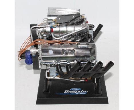 A Liberty Classics diecast and plastic scale replica of a Ford 427SOHC engine 1/16 scale housed on a plastic display plinth, 