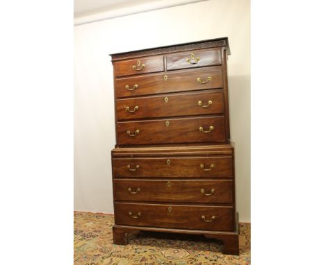 George III mahogany chest on chest with blind fret carved frieze, the upper section having two short over three long drawers 