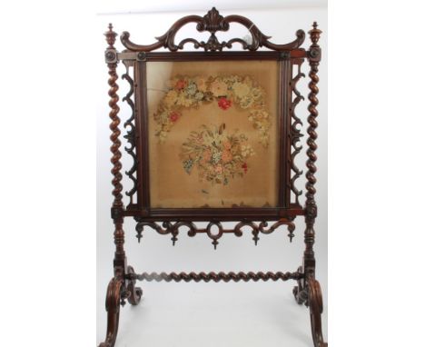 Early Victorian carved rosewood fire screen with rectangular floral tapestry banner with scrolled and barley-twist frame and 